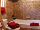 new bathroom with tumbled marble tub.
